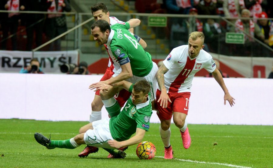 Gracze reprezentacji Polski Kamil Grosicki (P) i Robert Lewandowski (L - tył) oraz Seamus Coleman (dół) i John O'Shea (C) z Irlandii w meczu grupy D eliminacji piłkarskich mistrzostw Europy 2016